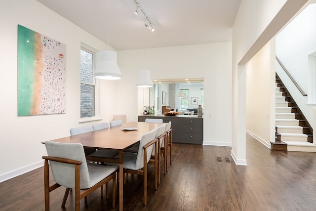 2117 W Dickens Ave, Chicago, IL 60647 - dining space with stairway, dark wood finished floors, rail lighting, and baseboards