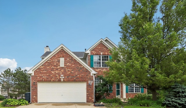 263 Thrush Cir, Lindenhurst, IL 60046 - view of front facade featuring concrete driveway, brick siding, and a chimney