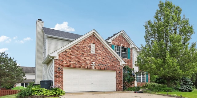 263 Thrush Cir, Lindenhurst, IL 60046 - traditional-style home featuring a chimney, concrete driveway, brick siding, and an attached garage