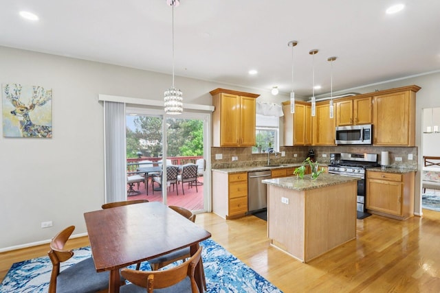 263 Thrush Cir, Lindenhurst, IL 60046 - kitchen featuring stainless steel appliances, a sink, tasteful backsplash, light wood-style flooring, and a center island