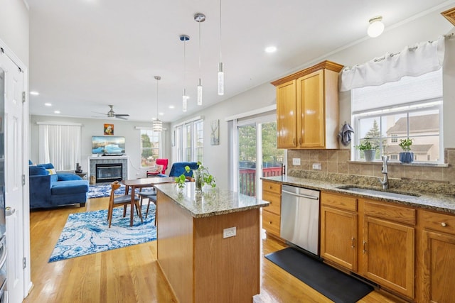 263 Thrush Cir, Lindenhurst, IL 60046 - kitchen with dishwasher, a tile fireplace, a sink, ceiling fan, and light wood finished floors
