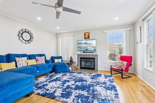 263 Thrush Cir, Lindenhurst, IL 60046 - living room with wood finished floors, a tiled fireplace, ceiling fan, baseboards, and recessed lighting