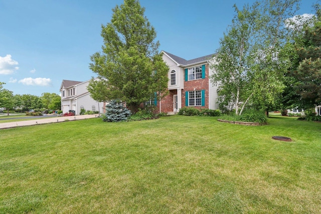 263 Thrush Cir, Lindenhurst, IL 60046 - view of front facade with brick siding, a front yard, and driveway