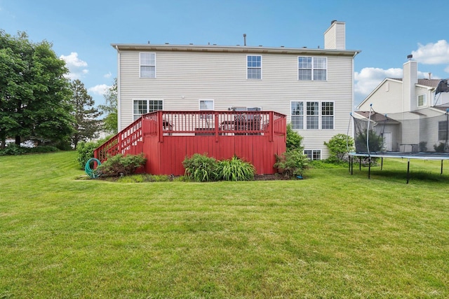 263 Thrush Cir, Lindenhurst, IL 60046 - rear view of house featuring a trampoline, a deck, a lawn, and a chimney