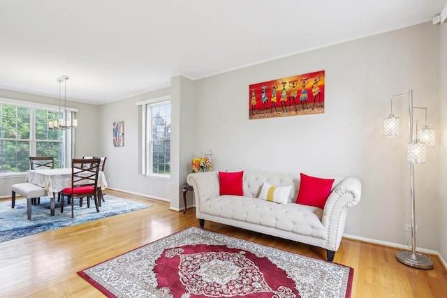 263 Thrush Cir, Lindenhurst, IL 60046 - living room with wood finished floors, a chandelier, baseboards, and crown molding
