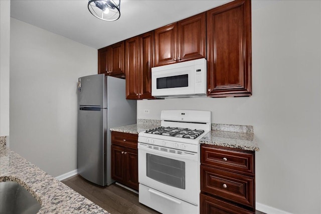1330 Woodcutter Ln, Wheaton, IL 60189 - kitchen featuring white appliances, dark wood-style floors, baseboards, and light stone countertops