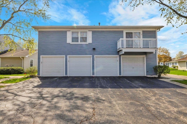 1330 Woodcutter Ln, Wheaton, IL 60189 - view of front facade featuring asphalt driveway, a garage, and a balcony
