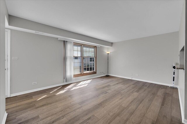 1330 Woodcutter Ln, Wheaton, IL 60189 - unfurnished living room with wood finished floors and baseboards