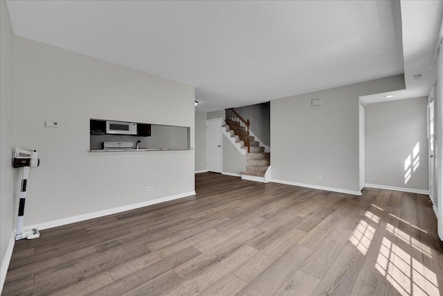 1330 Woodcutter Ln, Wheaton, IL 60189 - unfurnished living room featuring wood finished floors, stairs, and baseboards