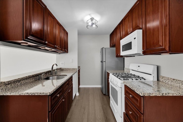 1330 Woodcutter Ln, Wheaton, IL 60189 - kitchen featuring white appliances, a sink, wood finished floors, baseboards, and light stone countertops
