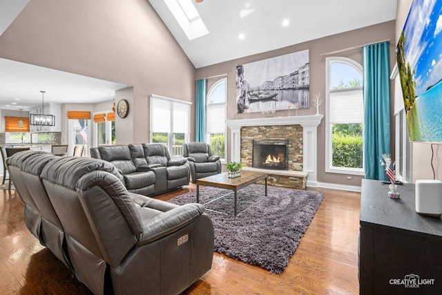 2417 Wentworth Ln, Aurora, IL 60502 - living room with a chandelier, recessed lighting, a stone fireplace, wood finished floors, and healthy amount of natural light