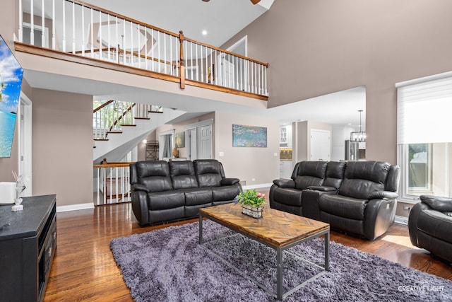 2417 Wentworth Ln, Aurora, IL 60502 - living area featuring a high ceiling, baseboards, wood finished floors, plenty of natural light, and stairway