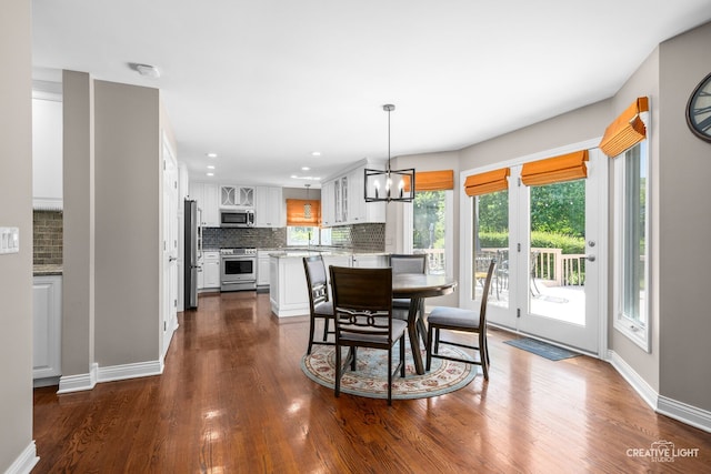 2417 Wentworth Ln, Aurora, IL 60502 - dining area with a chandelier, dark wood-style flooring, baseboards, and recessed lighting