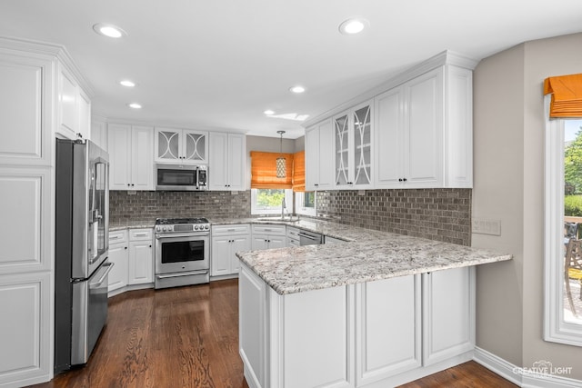 2417 Wentworth Ln, Aurora, IL 60502 - kitchen featuring stainless steel appliances, a peninsula, a sink, white cabinets, and recessed lighting