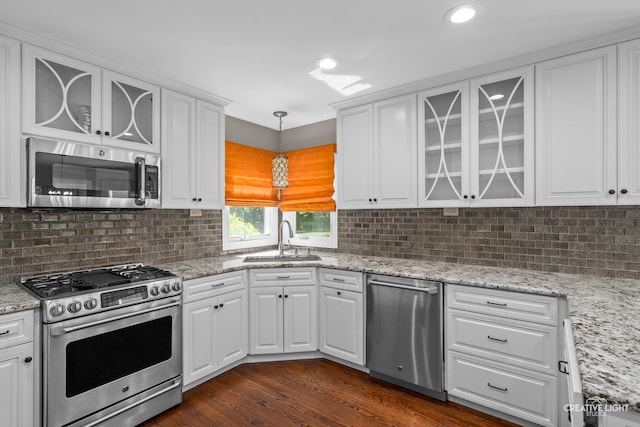 2417 Wentworth Ln, Aurora, IL 60502 - kitchen featuring appliances with stainless steel finishes, a sink, white cabinets, tasteful backsplash, and recessed lighting