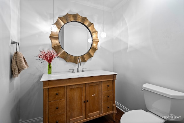 2417 Wentworth Ln, Aurora, IL 60502 - bathroom featuring toilet, vanity, crown molding, wood finished floors, and baseboards