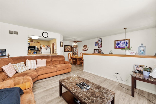 46 Harmony Ln, Romeoville, IL 60446 - living area featuring light wood-type flooring, ceiling fan, and baseboards