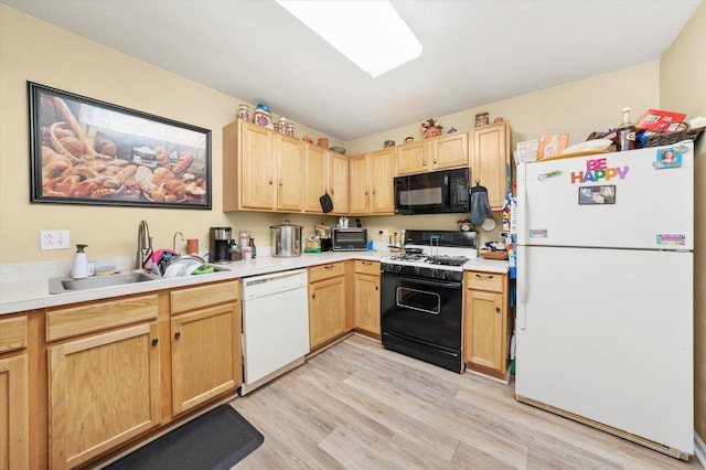 46 Harmony Ln, Romeoville, IL 60446 - kitchen featuring black appliances, a sink, light wood finished floors, and light brown cabinets