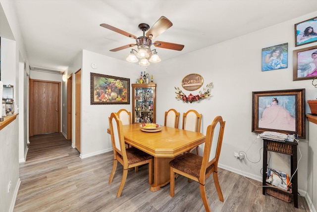 46 Harmony Ln, Romeoville, IL 60446 - dining area featuring light wood-style flooring, a ceiling fan, and baseboards