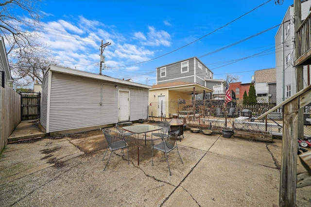 3238 N Whipple St, Chicago, IL 60618 - back of property featuring outdoor dining space, a patio area, and an outbuilding