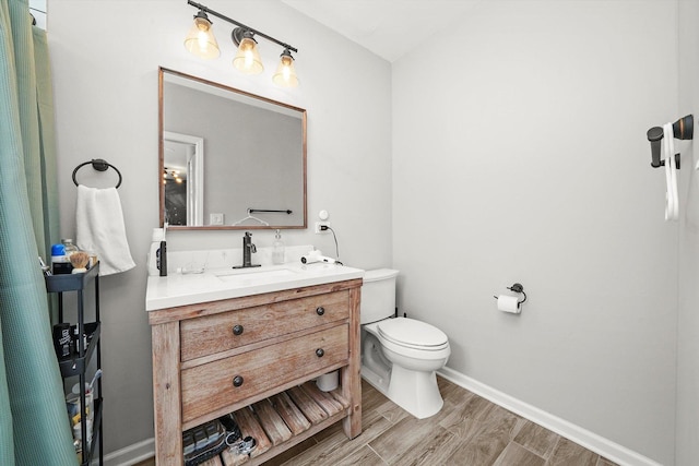 3238 N Whipple St, Chicago, IL 60618 - bathroom featuring vanity, toilet, baseboards, and wood finished floors