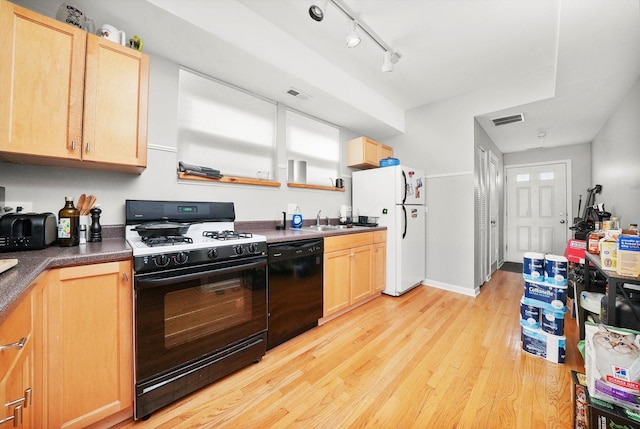 3238 N Whipple St, Chicago, IL 60618 - kitchen with black appliances, light brown cabinets, light wood-style floors, and a sink