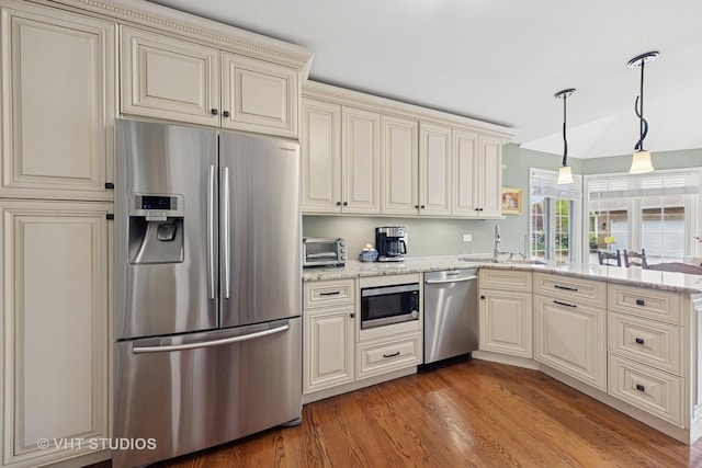 13922 Steepleview Ln, Lemont, IL 60439 - kitchen with appliances with stainless steel finishes, cream cabinetry, a peninsula, light wood-style flooring, and light stone countertops