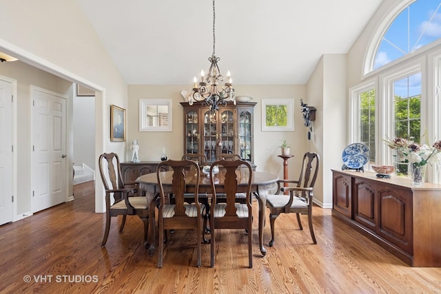 13922 Steepleview Ln, Lemont, IL 60439 - dining room with lofted ceiling, light wood-style floors, and a chandelier