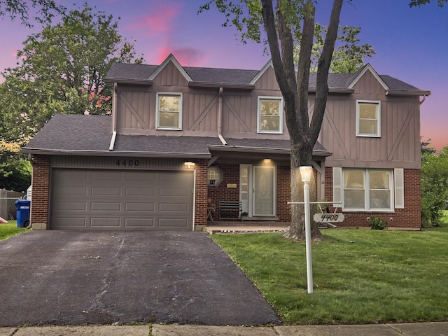4400 Waubansie Ln, Lisle, IL 60532 - view of front of property featuring board and batten siding, asphalt driveway, and a yard
