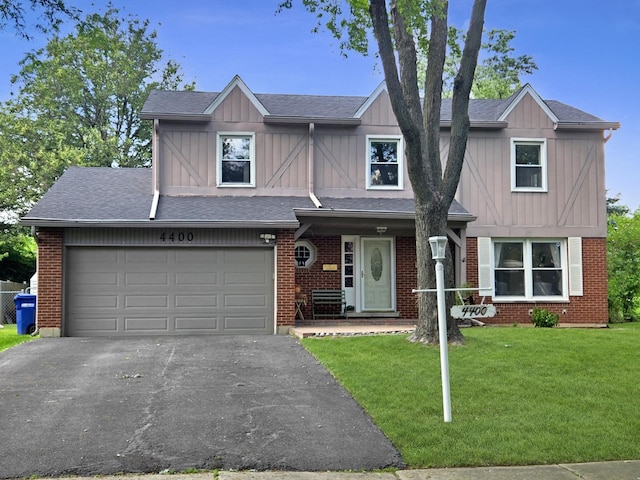 4400 Waubansie Ln, Lisle, IL 60532 - view of front facade with board and batten siding, a front yard, asphalt driveway, and brick siding