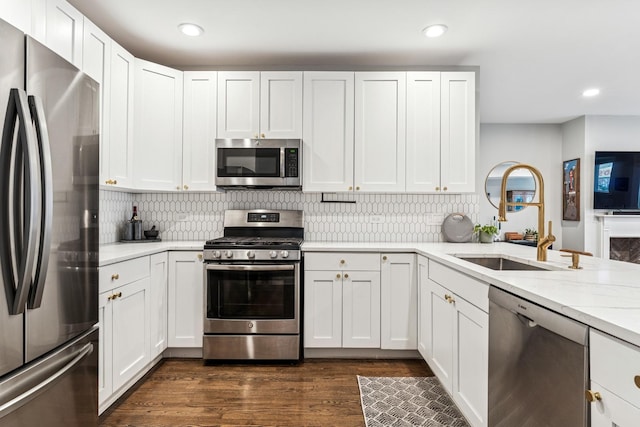2309 W Chicago Ave Unit 1, Chicago, IL 60622 - kitchen with appliances with stainless steel finishes, a sink, dark wood-style flooring, recessed lighting, and white cabinets