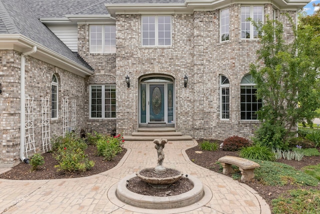 499 Waubonsee Cir, Oswego, IL 60543 - entrance to property with roof with shingles and brick siding