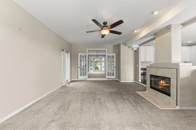 499 Waubonsee Cir, Oswego, IL 60543 - unfurnished living room featuring ceiling fan, a fireplace, baseboards, and carpet