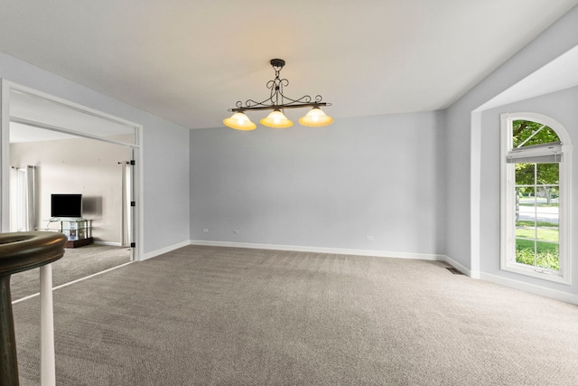 499 Waubonsee Cir, Oswego, IL 60543 - carpeted spare room with baseboards and a chandelier