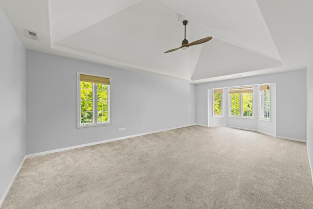 499 Waubonsee Cir, Oswego, IL 60543 - carpeted spare room featuring ceiling fan, plenty of natural light, a tray ceiling, baseboards, and lofted ceiling