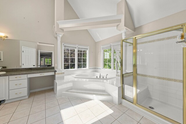 499 Waubonsee Cir, Oswego, IL 60543 - bathroom with vaulted ceiling, vanity, a garden tub, tile patterned floors, and a stall shower