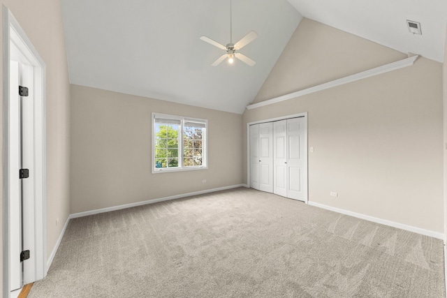 499 Waubonsee Cir, Oswego, IL 60543 - unfurnished bedroom featuring high vaulted ceiling, baseboards, carpet flooring, a closet, and ceiling fan