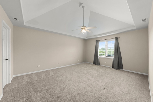 499 Waubonsee Cir, Oswego, IL 60543 - carpeted spare room with a raised ceiling, a ceiling fan, baseboards, and lofted ceiling