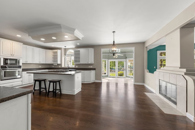 499 Waubonsee Cir, Oswego, IL 60543 - kitchen featuring stainless steel appliances, recessed lighting, dark countertops, dark wood finished floors, and glass insert cabinets