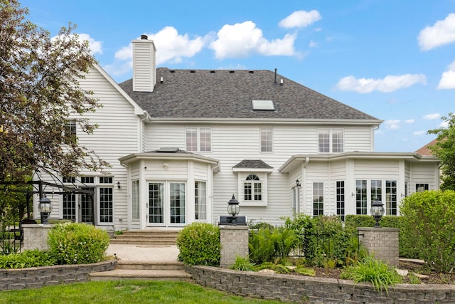 499 Waubonsee Cir, Oswego, IL 60543 - rear view of house featuring a chimney, roof with shingles, and french doors
