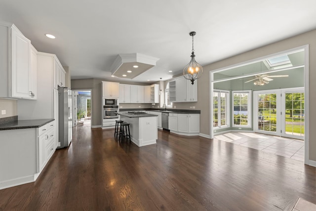 499 Waubonsee Cir, Oswego, IL 60543 - kitchen with appliances with stainless steel finishes, dark countertops, white cabinets, and recessed lighting