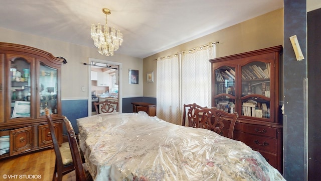 6522 N Sacramento Ave, Chicago, IL 60645 - dining area featuring a chandelier and wood finished floors