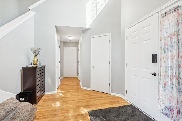 4801 Bordeaux Dr, Lake In The Hills, IL 60156 - foyer entrance featuring light wood-type flooring, a towering ceiling, and baseboards
