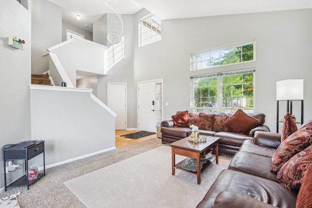 4801 Bordeaux Dr, Lake In The Hills, IL 60156 - carpeted living area with a high ceiling, plenty of natural light, stairway, and baseboards