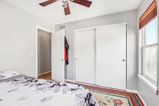 4801 Bordeaux Dr, Lake In The Hills, IL 60156 - carpeted bedroom featuring a closet, multiple windows, baseboards, and ceiling fan
