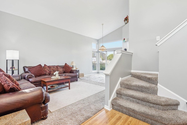4801 Bordeaux Dr, Lake In The Hills, IL 60156 - carpeted living area featuring stairway, baseboards, wood finished floors, and vaulted ceiling