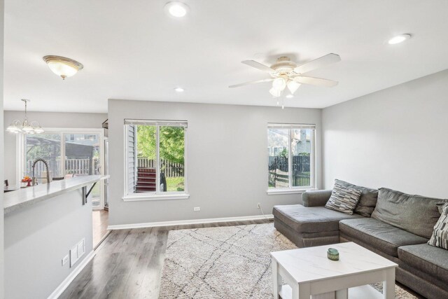 4801 Bordeaux Dr, Lake In The Hills, IL 60156 - living area featuring wood finished floors, a ceiling fan, baseboards, recessed lighting, and a chandelier