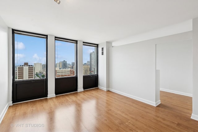 444 W Fullerton Pkwy Unit 1702, Chicago, IL 60614 - empty room with wood finished floors and a view of city