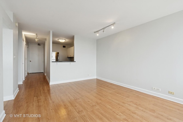 444 W Fullerton Pkwy Unit 1702, Chicago, IL 60614 - unfurnished living room with light wood-type flooring and rail lighting
