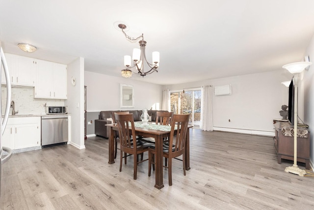 1053 W Ogden Ave Unit 3-149, Naperville, IL 60563 - dining area with a baseboard radiator, a chandelier, light wood-style flooring, baseboards, and a wall unit AC